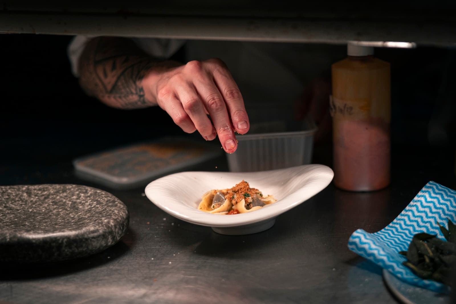 Chef finishing a tortelloni dish at the pass
